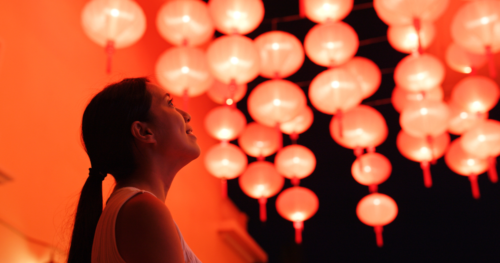 A woman looking up at a bunch of red lanterns for the Lunar New Year during winter in Ohio