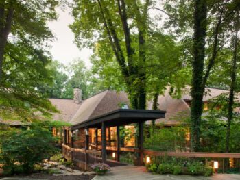 One of the best resorts in Ohio nestled in the woods with a wooden walkway and lanterns