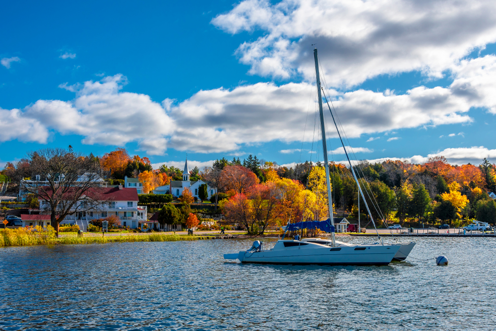 Village of Ephraim harbour view in Door County of Wisconsin. There is a boat in the foreground. The article is about  towns in Door County