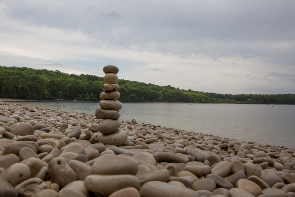 Schoolhouse Beach in Washington Island Wisconsin. Stones and piled up on the beach. The article is about towns in door county 