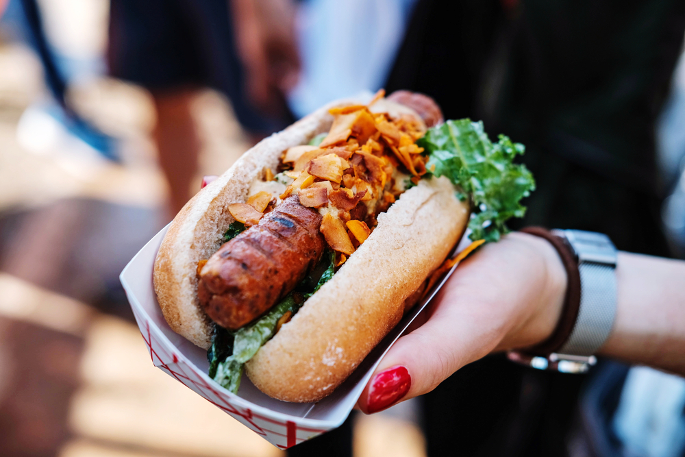 Vegan hotdog been held in a hand in an article about vegan restaurants in Chicago