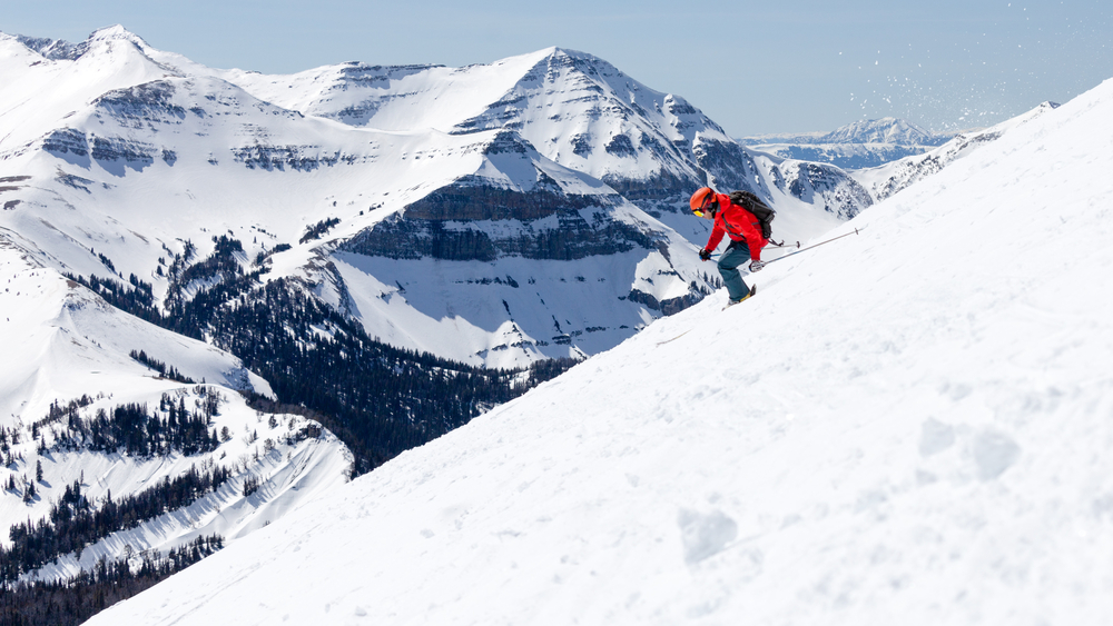 A skier going down a snowy slope at Big Sky Resort in Montana.