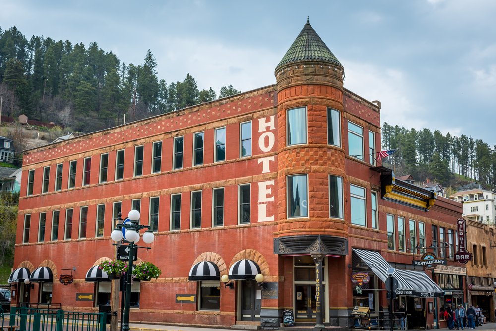 Exterior of the red, historic Fairmont Hotel, one of the most haunted places in Deadwood.