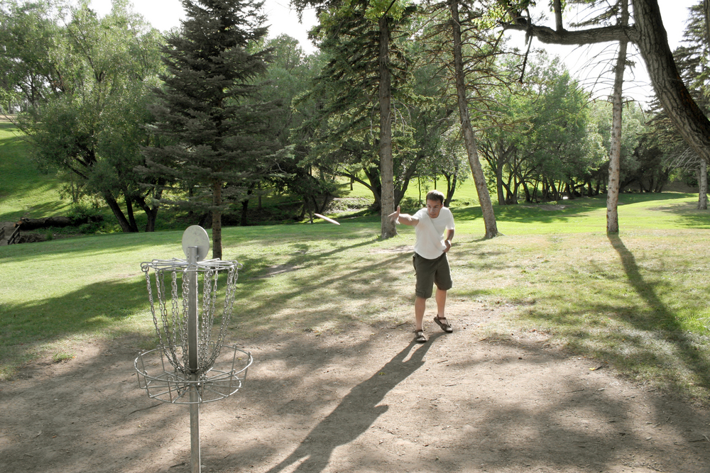 A man playing frisbee golf in a park things to do in billings