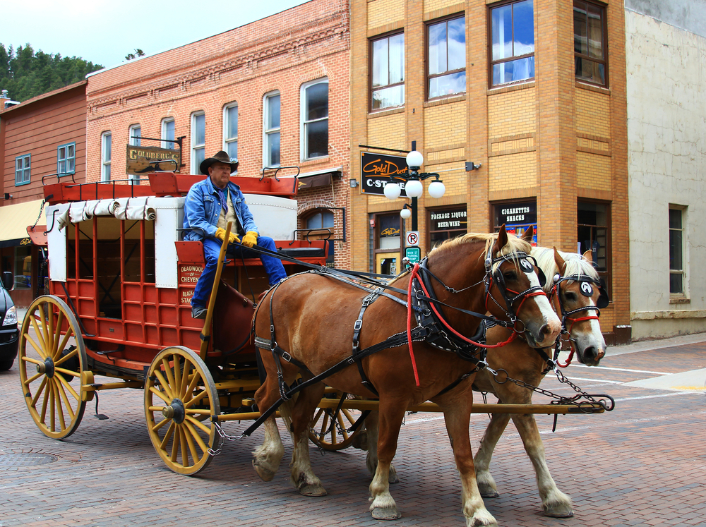Horse-drawn stagecoach going down Main Street in Deadwood.
