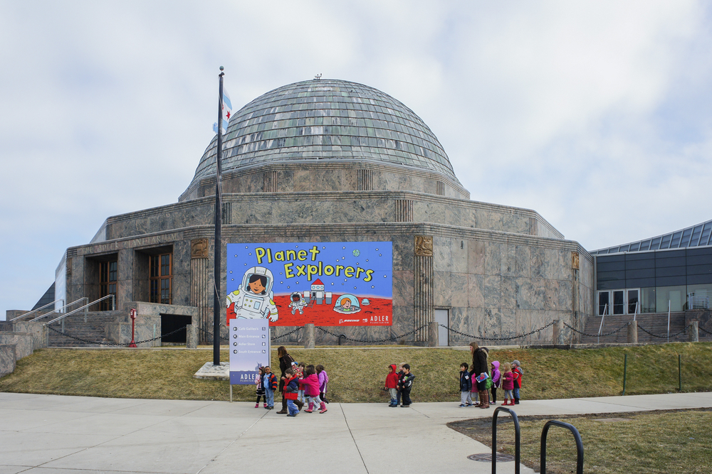 A group of kids walking outside the Adler Planetarium, one of the best things to do in Chicago with kids
