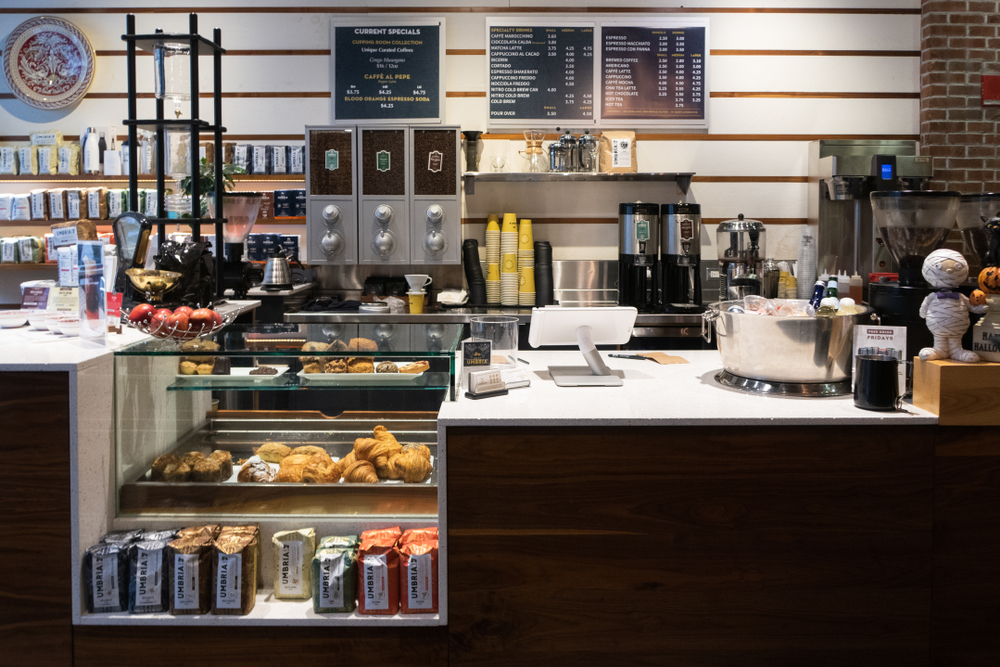 The interior of a coffee shop in Chicago where there is coffee, pastries, and coffee for sale