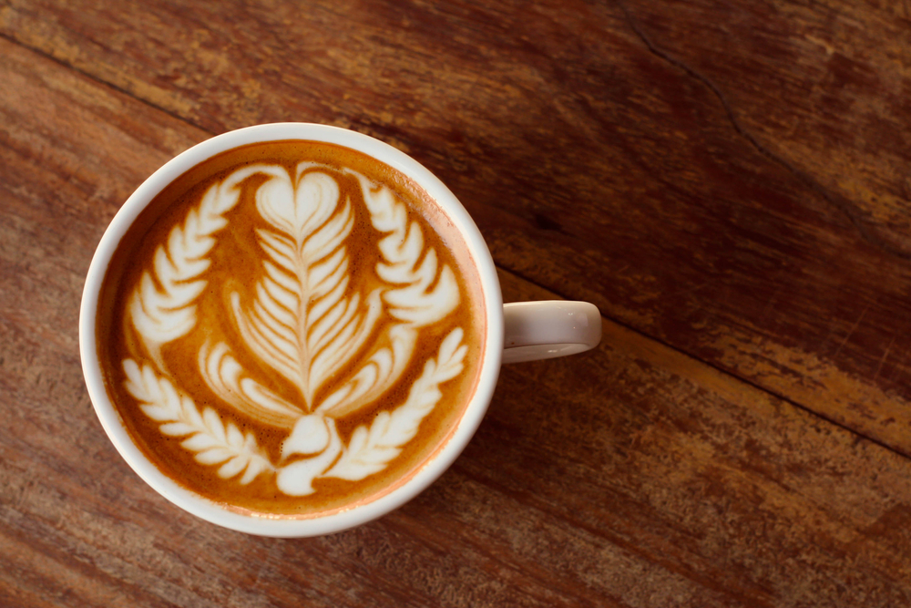Looking down at a latte with an intricate latte art design made at one of the best coffee shops in Chicago