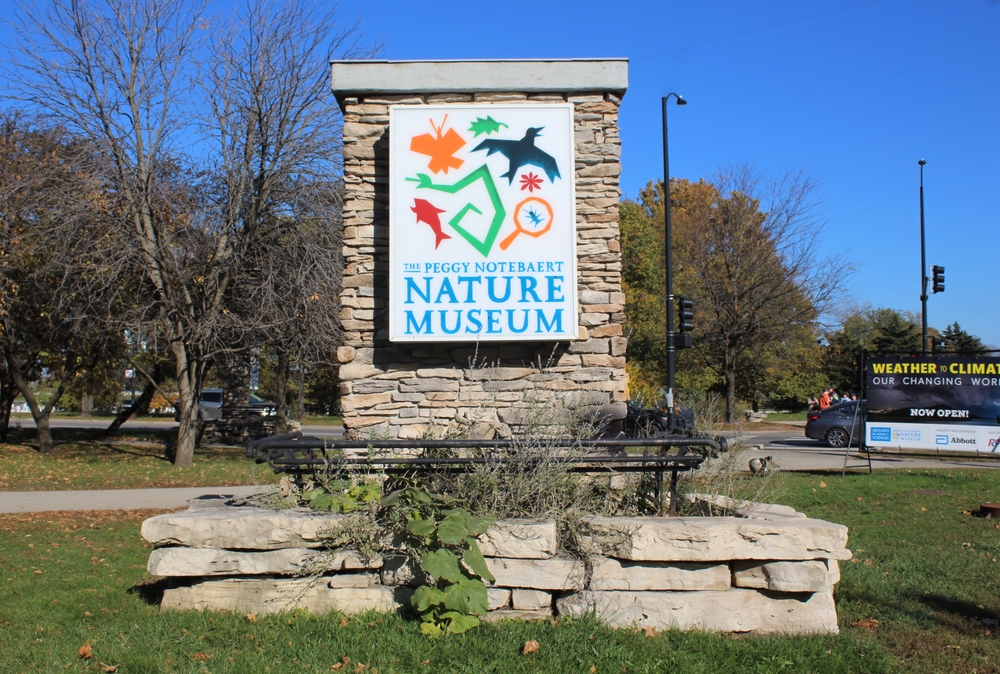 The sign at the entrance of the Peggy Notebaert Nature Museum on a sunny day