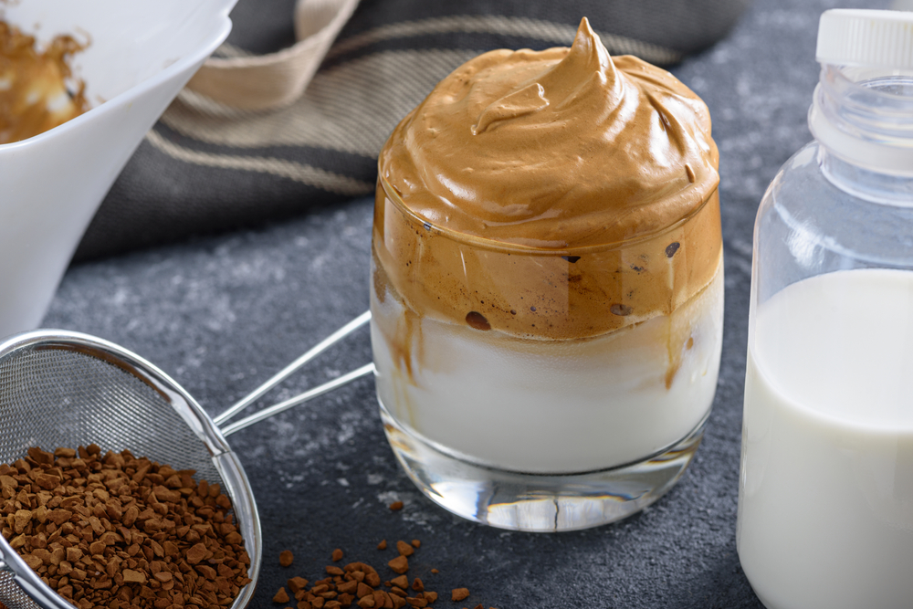 A unique whipped coffee drink in a small clear glass