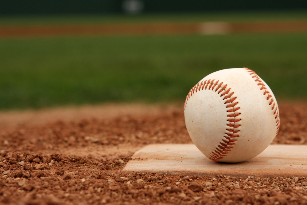 Close up photo of a baseball on the pitcher's mound.