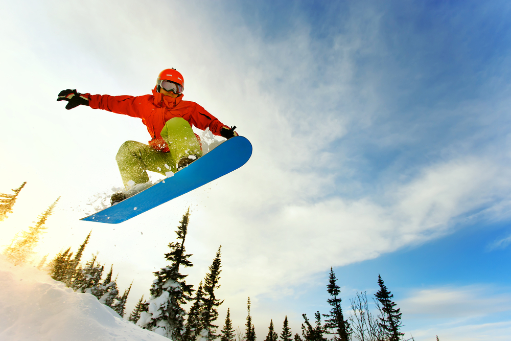 snowboarder jumping through the air winter in montana