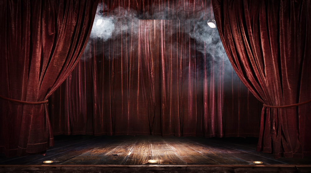 theatre stage with red curtains and show spotlights