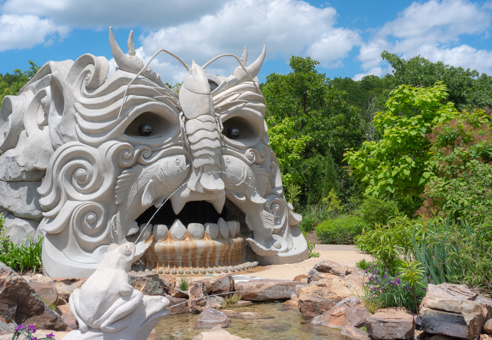 A large sculpture that looks like a face made out of fish and bugs in a botanical garden, one of the best things to do in Tulsa Oklahoma