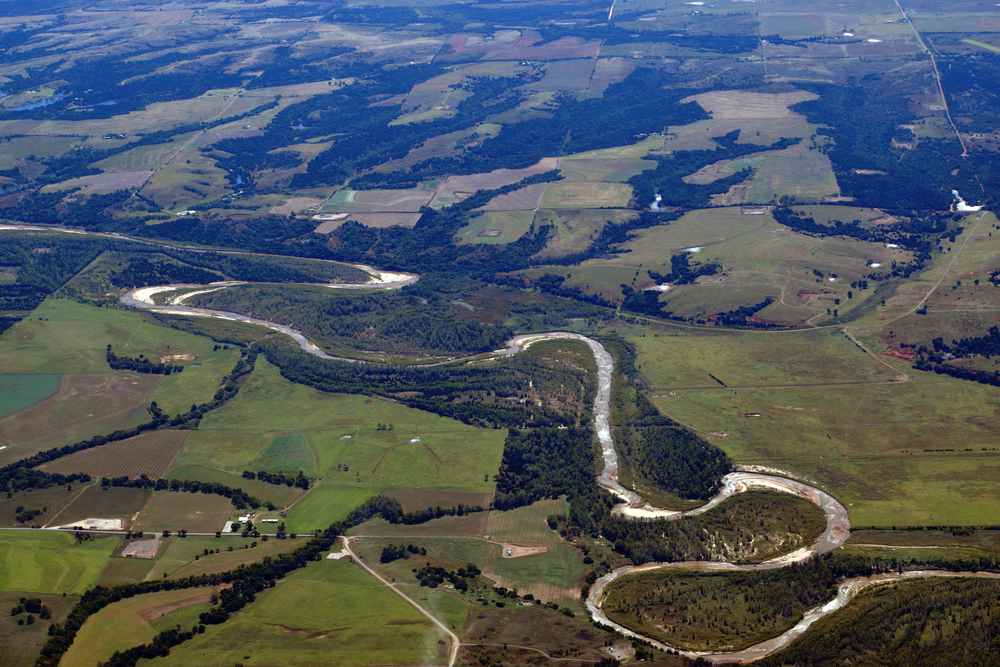 aerial view of a river flowing through greenery