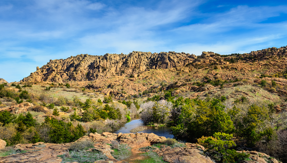 View of the rugged rock and scrubby landscape of the Wichita Mountains Wildlife Refuge