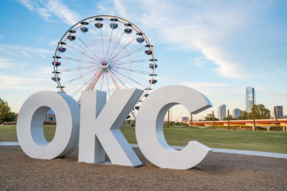 The big OKC sign with a Ferris wheel and the city skyline in the background.