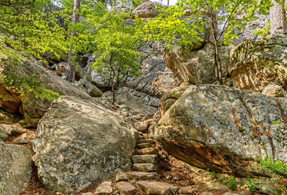 Stone stairs going up between large boulders on a trail in Oklahoma.