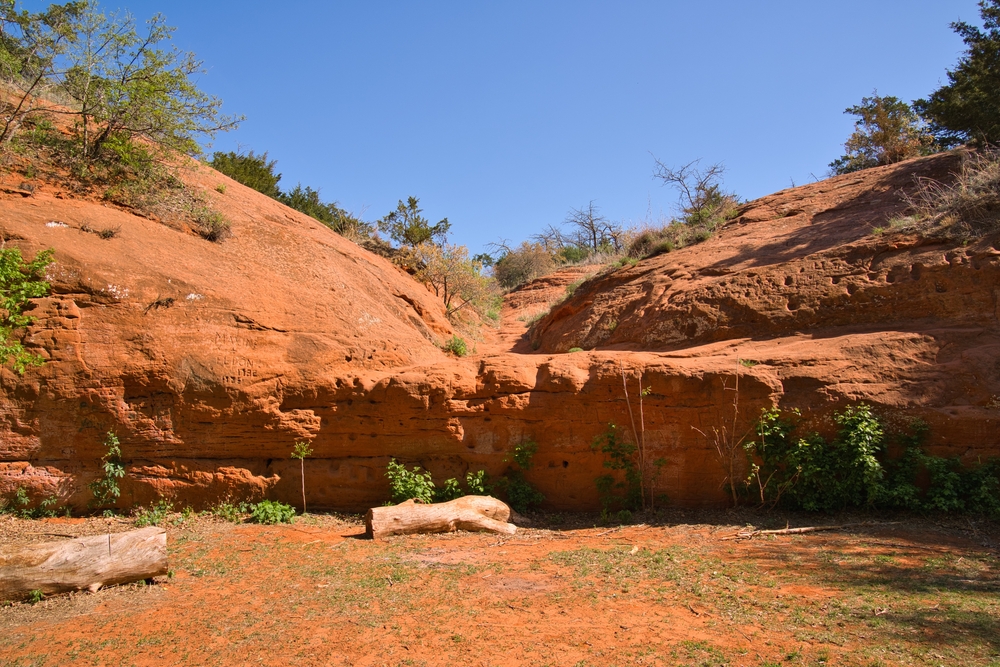 Beautiful red rocks and logs on a sunny day while hiking in Oklahoma.