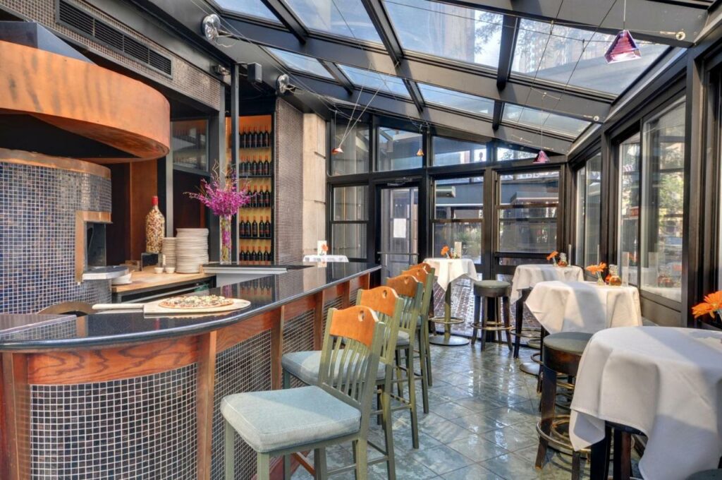 Restaurant with a pizza oven and skylights at The Whitehall Hotel. boutique hotels in Chicago