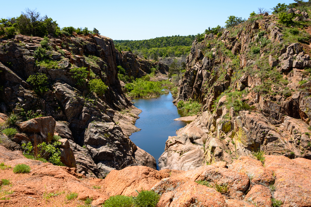 Cliff overlook of the rugged landscape and pond in the Wichita Mountains National Wildlife Refuge in Oklahoma.
