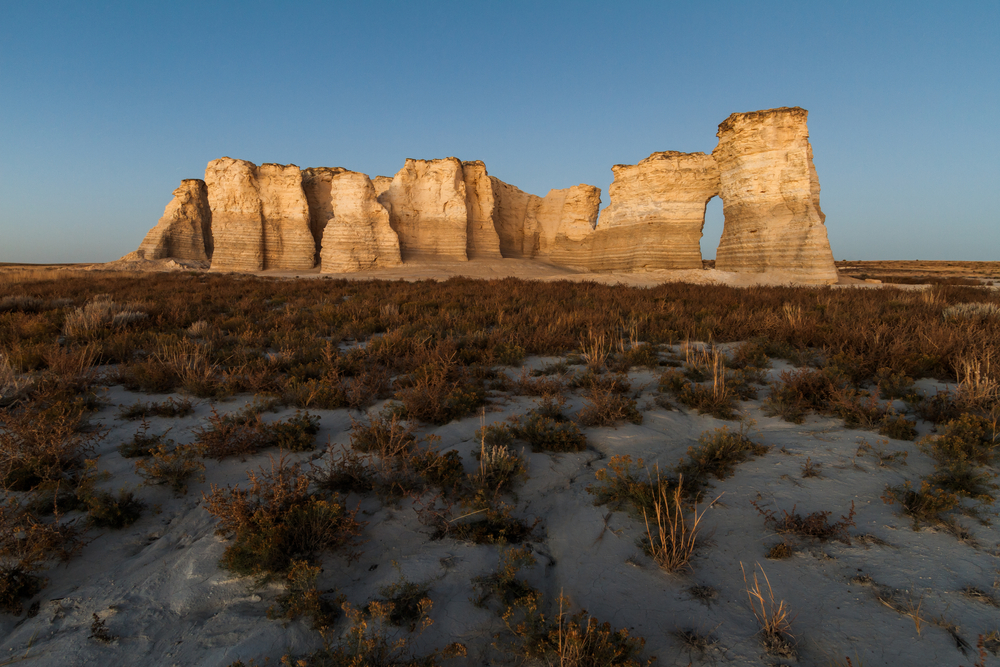 A horizontal landscape photography image of Monument Rocks in Kansas before sunset. They are also known as Chalk Pyramids.