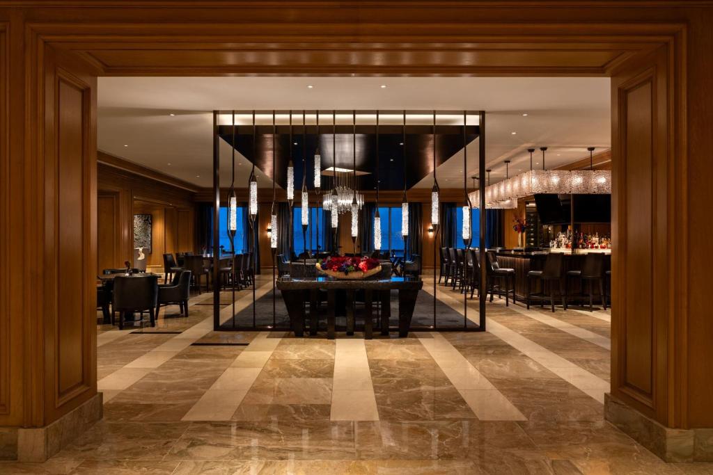 Hotel lobby with lots of wood and chairs around the bar