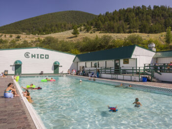 People swimming in the outdoor pool at Chico Hot Springs in Montana.