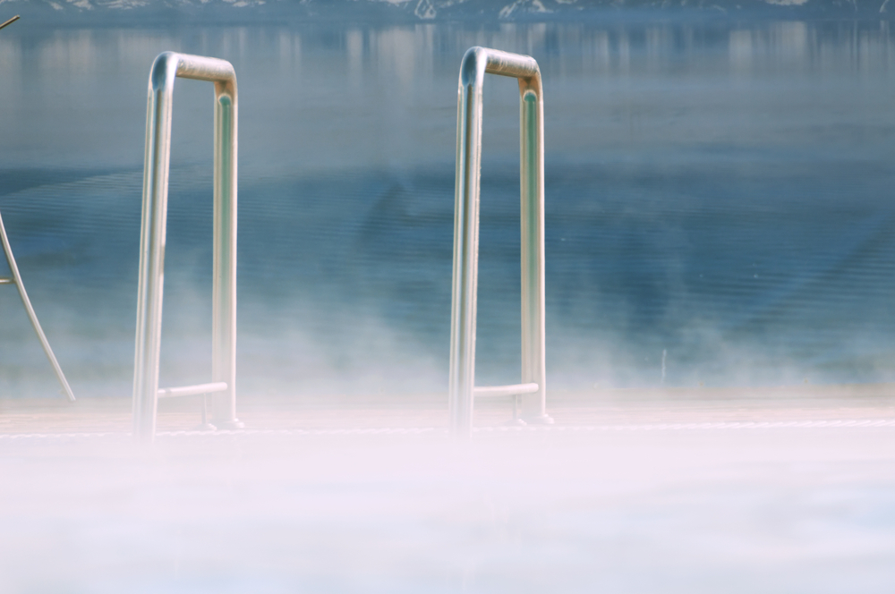 Ladder leading into a steaming pool.