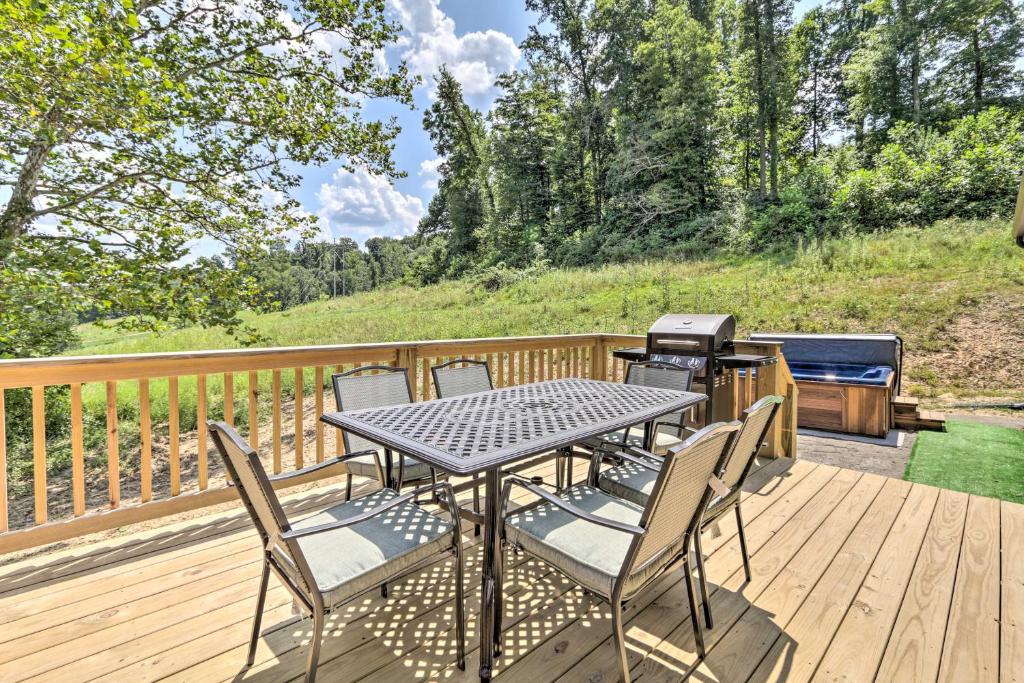 Picture showing the deck of a cabin leading to a hot tub. 