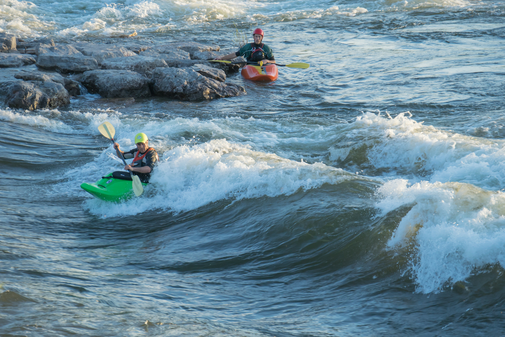 Kayakers in the Fork Clark River paddling on Brennan's Wave.