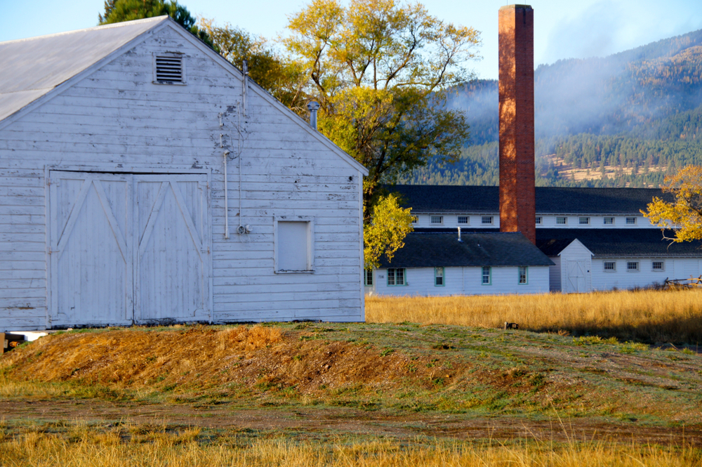 Fall day at Fort Missoula featuring old, white, wooden buildings.