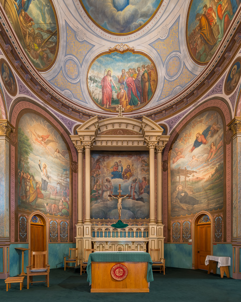 Interior of the St. Francis Xavier Church with many religious murals.