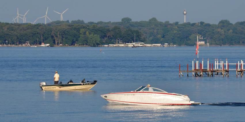 Picture showing boats on a lake with trees in the background. The article is on resorts in Iowa. 
