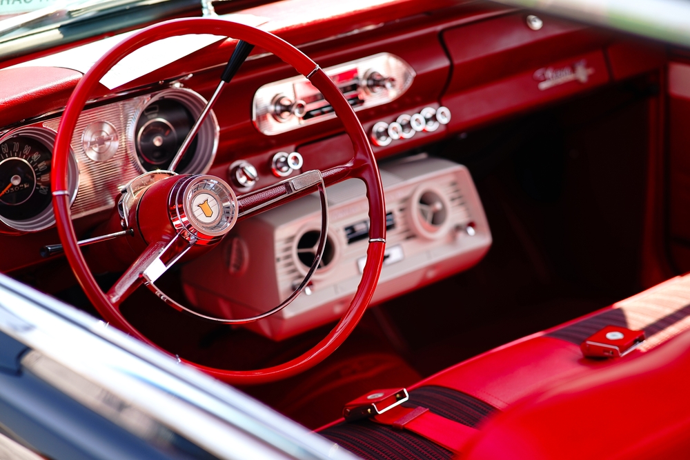 View through window of red interior of a classic car.