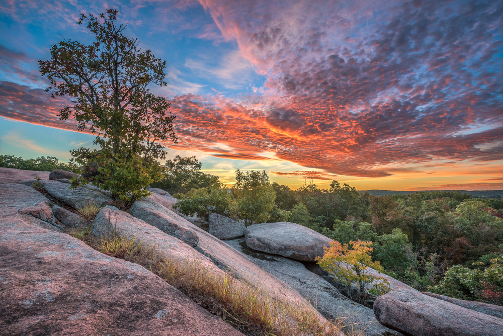 Vivid sunset over a vast view of Elephant Rocks State Park, one of the best attractions in Missouri.