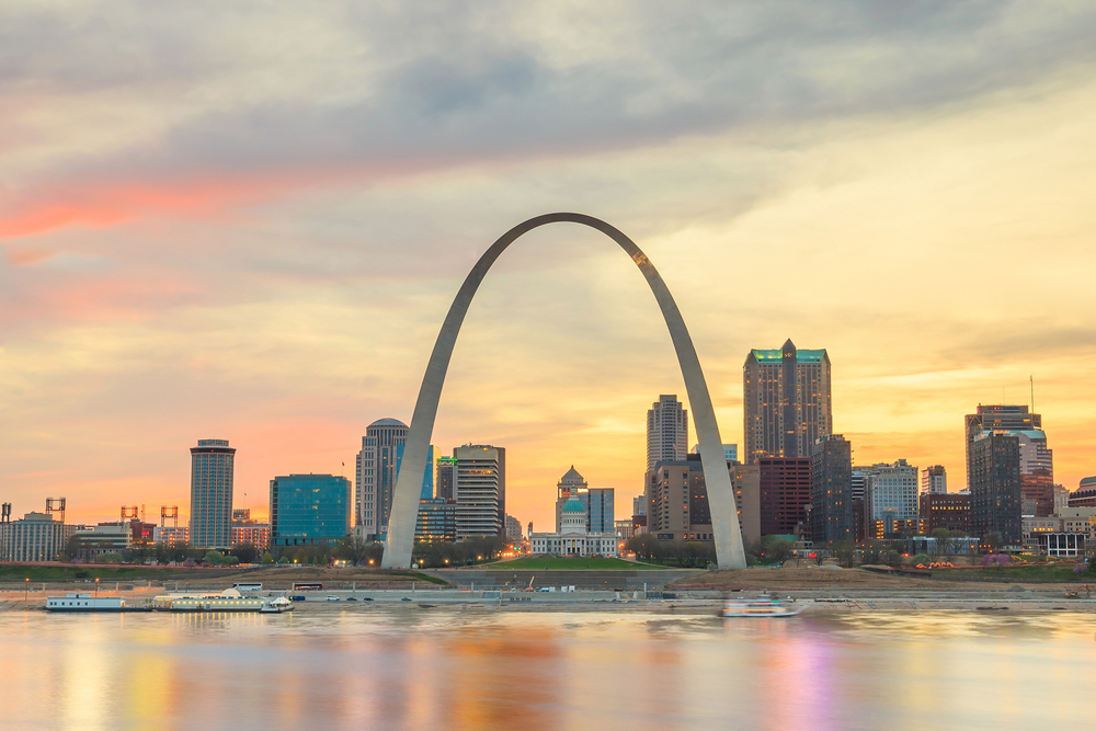 Orange sunset over the St. Louis skyline and Gateway Arch, one of the best attractions in Missouri.