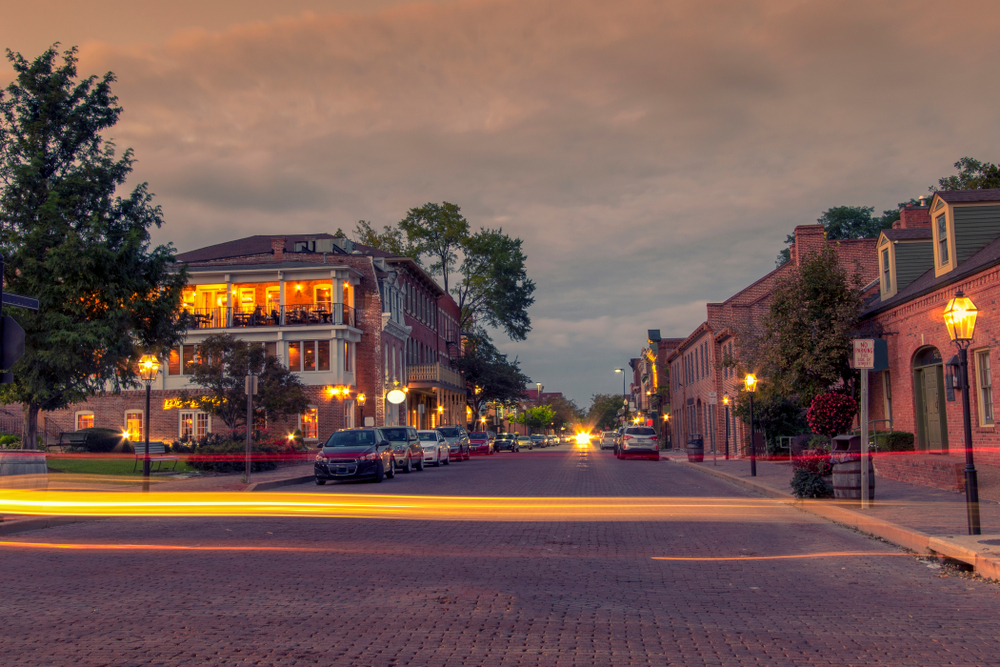 Evening photo of downtown St. Charles with lights from cars.