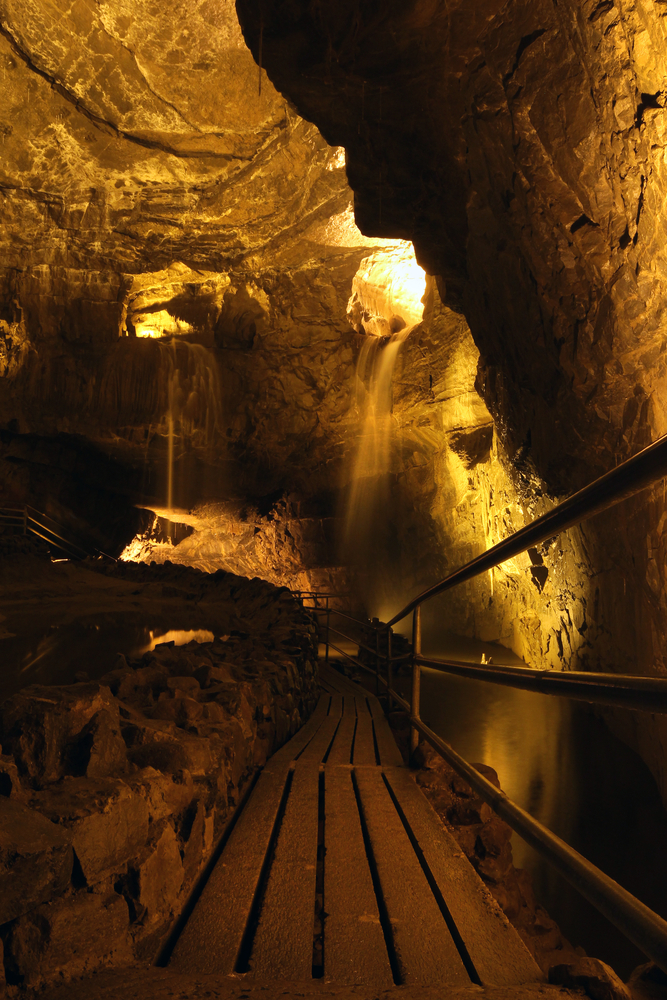 Walkway through Indiana Caverns with waterfalls.