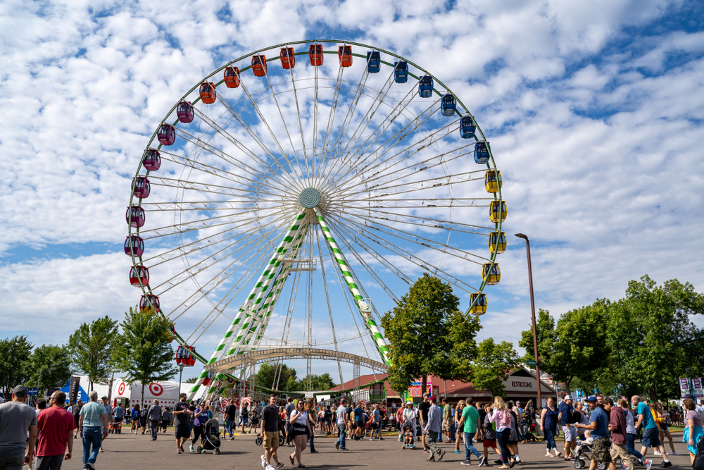 The Ferris wheel at the Minnesota State Fair with crowds walking around.
