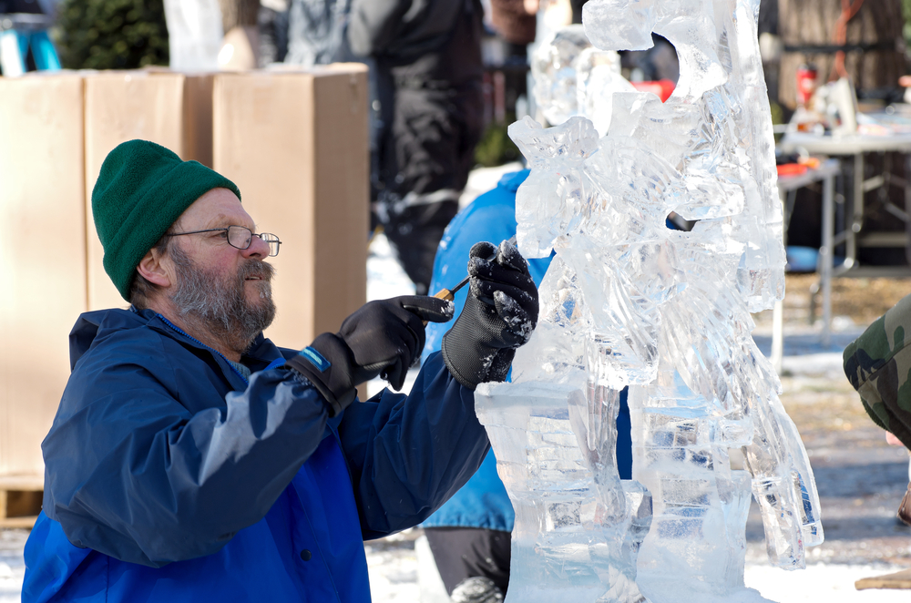A man ice sculpting at the Saint Paul Winter Carnival, one of the best events in Minnesota.