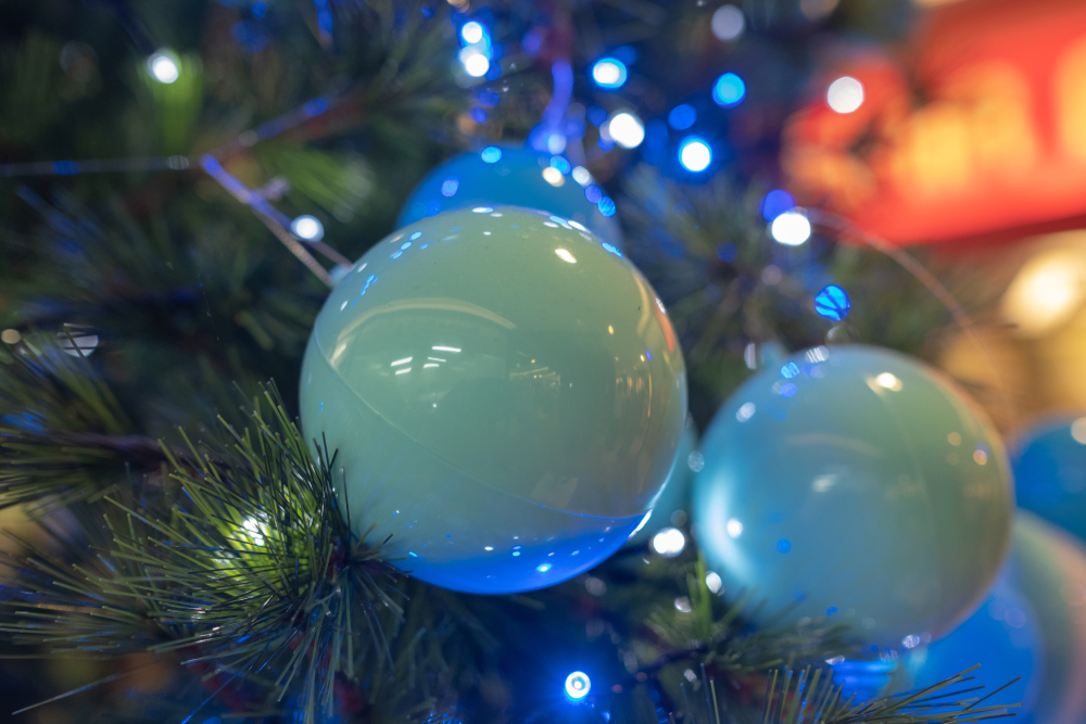 Blue ball with bokeh LED light decoration on the Christmas tree