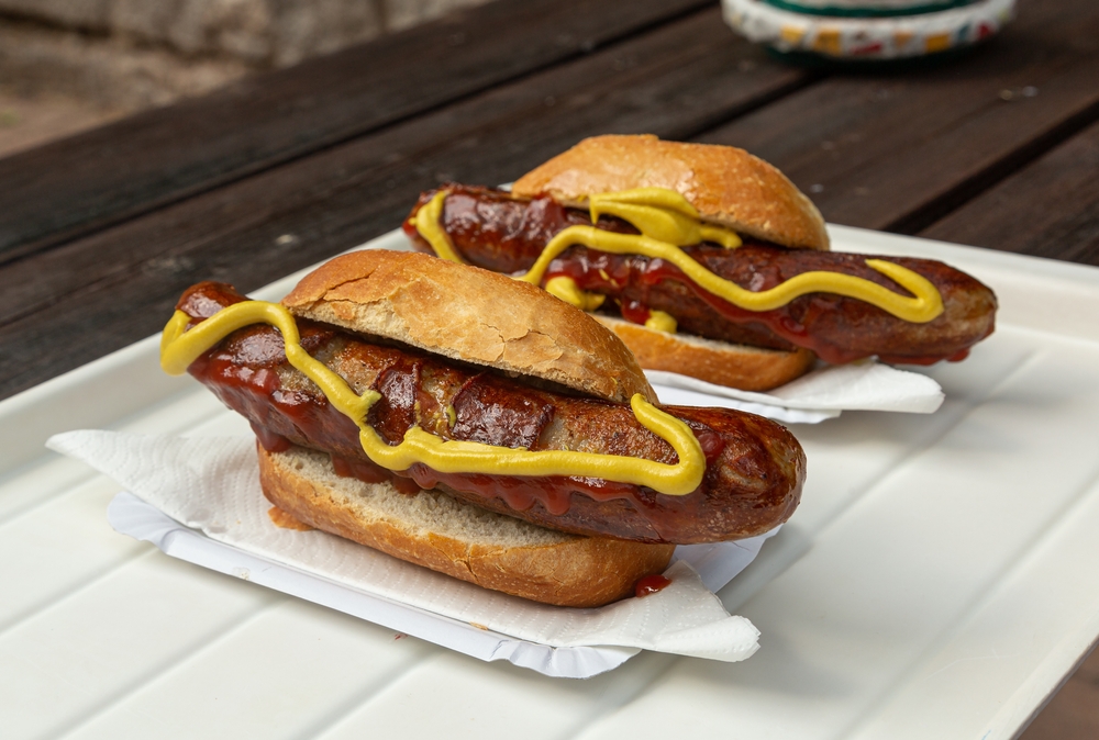 Bratwurst german natural sausages with sauce and bun in an article about events in Wisconsin