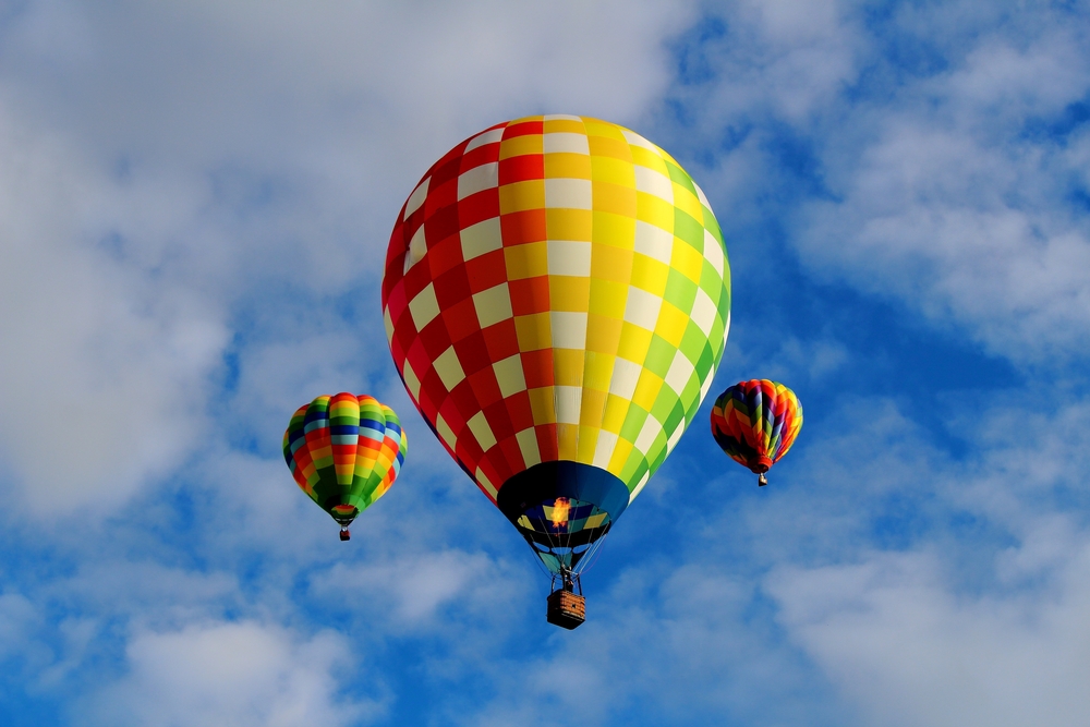Three colorful hot air balloons in the sky