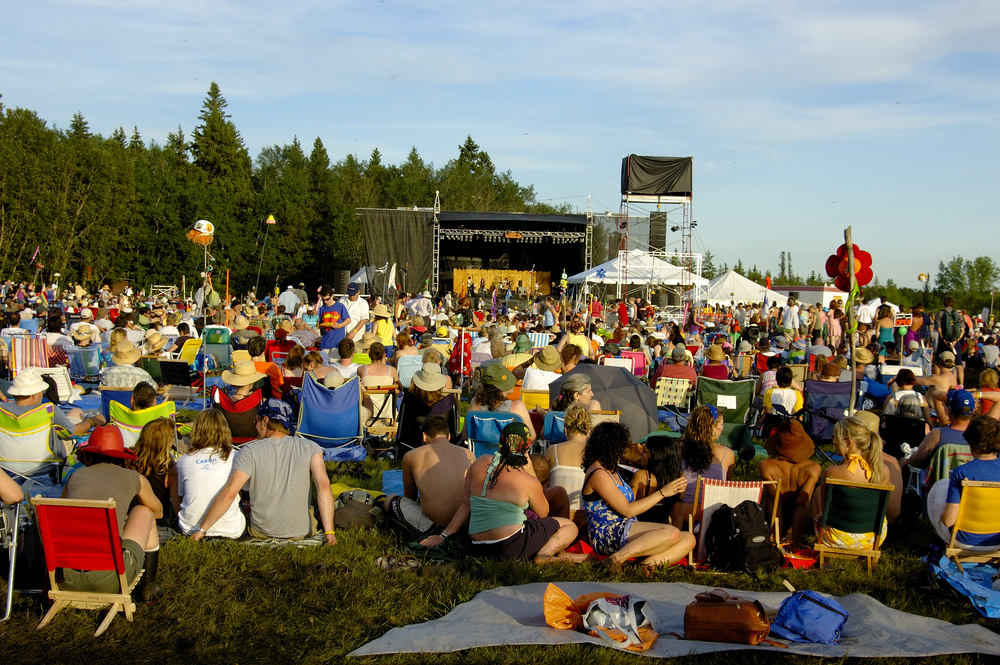 A large group of people at an outdoor summer music festival