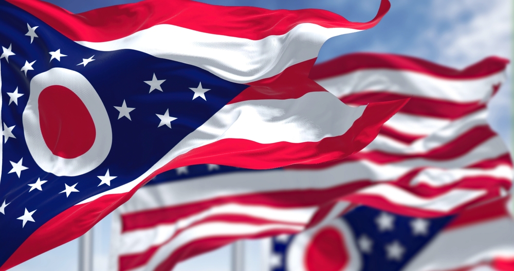 A closeup image of several Ohio state flags blowing in the wind