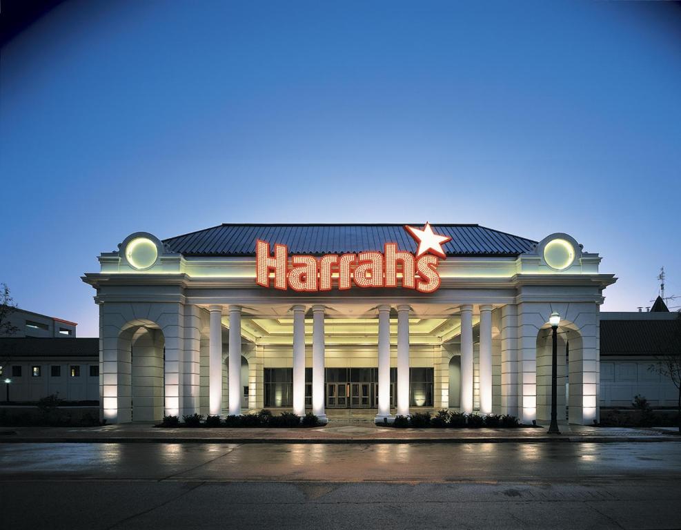 The outside of Harrahs. It's white with columns and a neaon sign with the name on. 