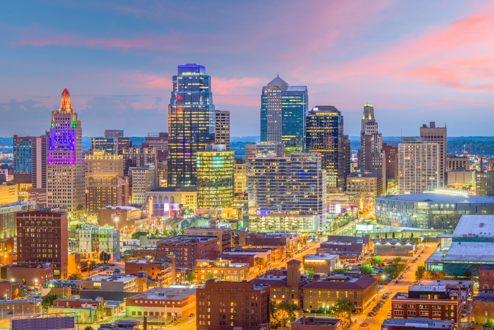 Aerial view of the downtown Kansas City skyline lit up at sunset.