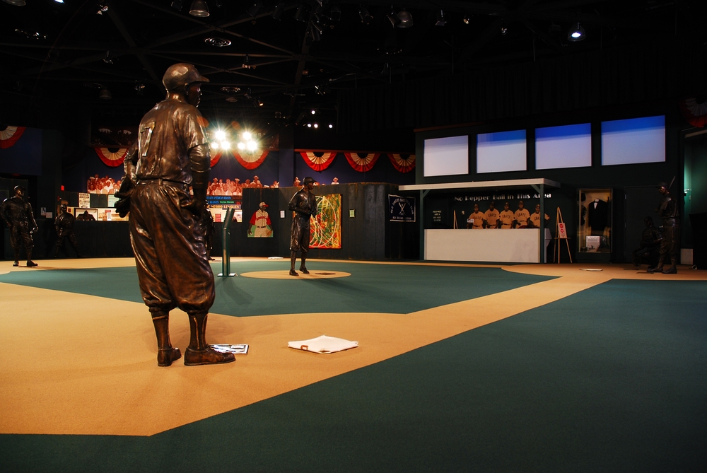 Inside the Negro Leagues Baseball Museum with baseball player statues and more exhibits.