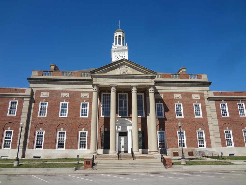 Brick courthouse with columns and clock tower in downtown Independence, MO.